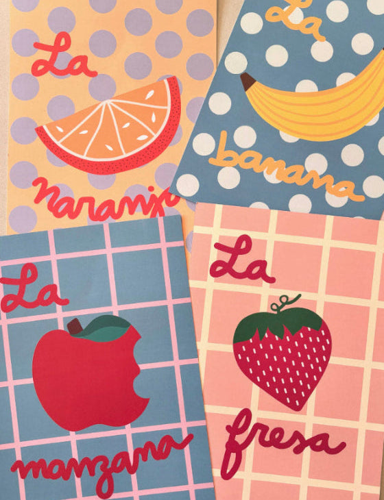 Four colorful prints with fruit illustrations and text on a polka dot and checkered background.